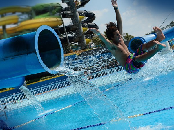 Man enjoying water slide at Hurricane Harbor