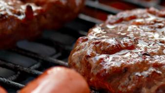 Patties and hot dogs on a grill