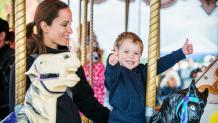 Mother and young son on carousel