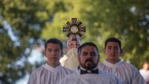 Religious garments on men leading a religious symbol