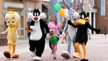 LOONEY TUNES characters walk with small child