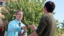 Six Flags offers a variety of services to help make the park experience more enjoyable. Six Flags team member handing out maps to guests