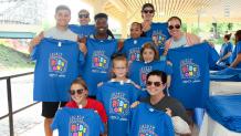 Event attendees holding t shirts