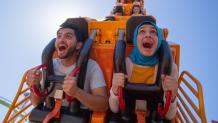 Couple riding Dare Devil Chaos Coaster