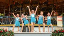 dance team performing by carousel