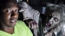 Male teen getting scared by a zombie on a ride at The Great Escape.