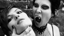 Female vampire tilting head of her next victim.