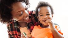 Mother smiling with happy child.