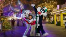 Bugs Bunny, Sylvester the Cat and a guest take in the lights of Holiday in the Park