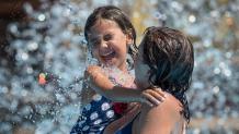 A mom and daughter get splashed at Six Flags Hurricane Harbor