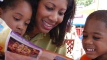 Mom explores the park map with her daughter and son