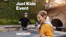 a young boy and girl dance around a ping pong table with phone in hand
