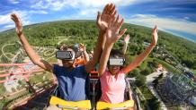 Riders in virtual reality headsets on SUPERMAN™ Ride of Steel