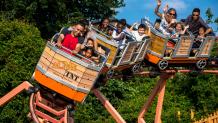 A father and daughter ride a roller coaster