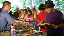 group of people being served in a buffet line