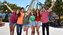 group of teens standing in a park midway