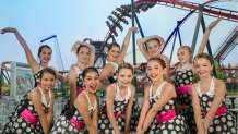 Group of girls on a Dance Team in front of X Flight