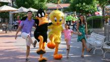 Family skipping with Looney Tunes characters