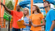 guests in park by roller coaster