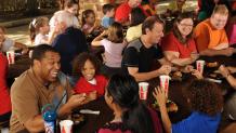 Large group eating at picnic tables