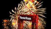 Fiesta Texas Drop Tower ride with fireworks in the background