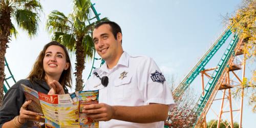security guard directing guest while looking at map