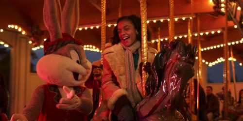 Bugs Bunny and a young girl riding the carousel at night