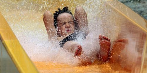Boy sliding down water slide