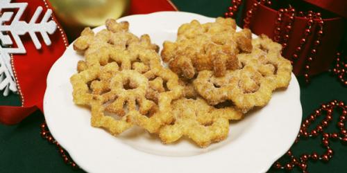 Buñuelos on a plate surrounded by holiday items