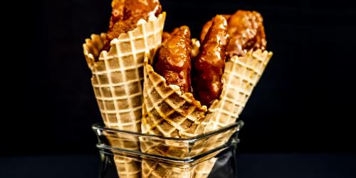 Crispy chicken tenders in a waffle cone with barbecue sauce