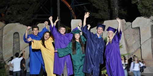 high school graduates celebrating in front of Goliath