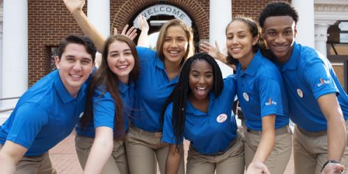 Group of Team Members posing together at front gate