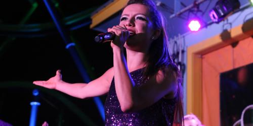 Mardi Gras Festival Entertainment performer singing on stage