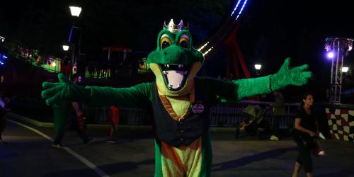 The Gator King posing after the nighttime Mardi Gras Festival parade