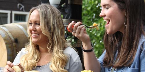 women eating sliders and pasta