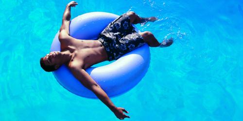 Man on inflatable tube, floating on lazy river