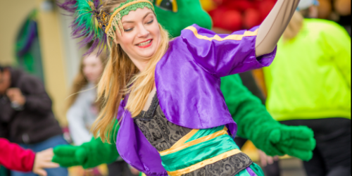 Performer dancing at the Mardi Gras festival with colorful clothing