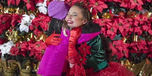 young girl hugging poinsettia princess