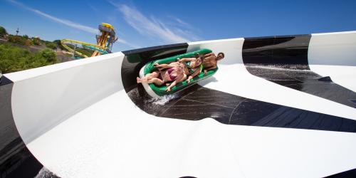 Guests on tube in water coaster turn