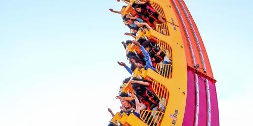 Red and orange loop coaster moving downward on an angle