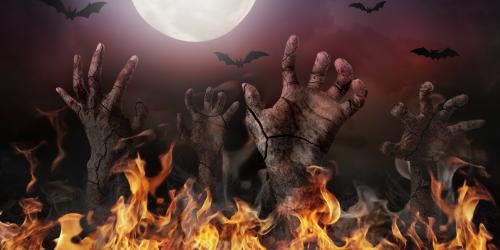 Zombie hands reaching up out of fire