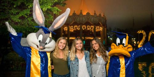 grad nite guests with Bugs and Daffy in their graduation gowns