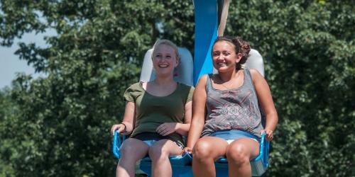 Girls riding on soarin eagles zip line