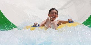Guest in inner tube sliding down a waterslide