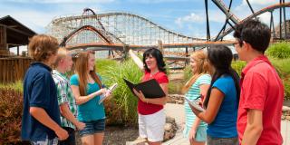Teacher with students learning about roller coasters Teacher with students learning about roller coasters