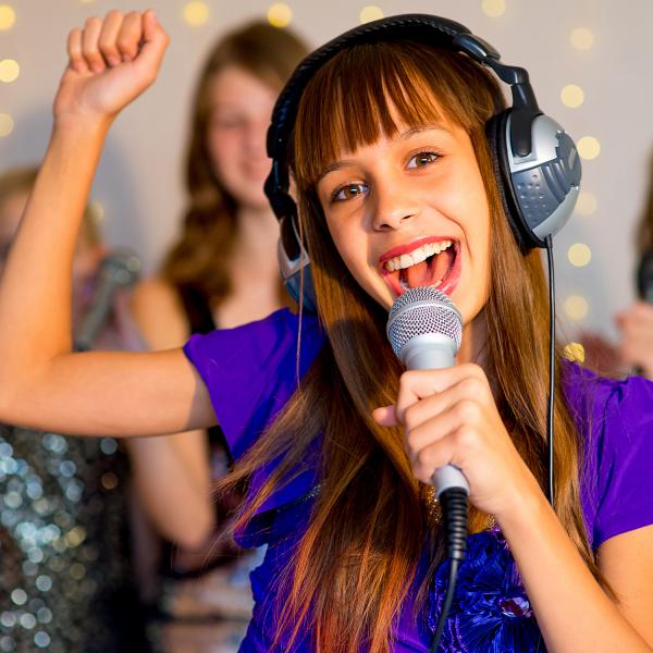 Girl performing song for people.