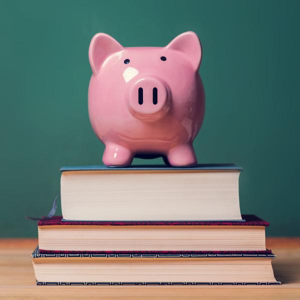 Piggy bank on a pile of books.