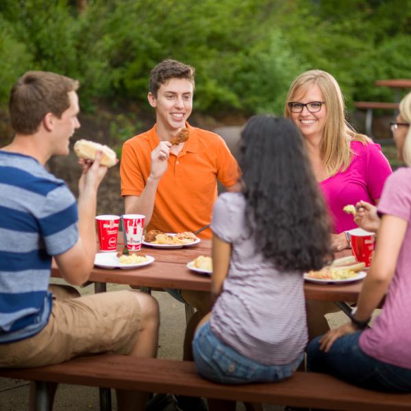 Teens eating in our Picnic Grove
