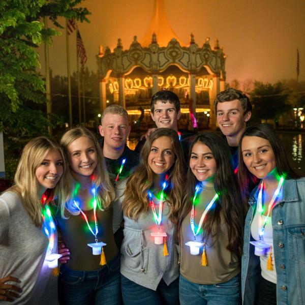 Grad Nite visitors wearing their Grad Nite gift necklaces outside the Carousel