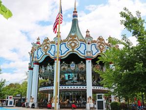 Wide Sof The Carousel With American Flag And Crystal Clear Blue Skies Wide Sof The Carousel With American Flag And Crystal Clear Blue Skies